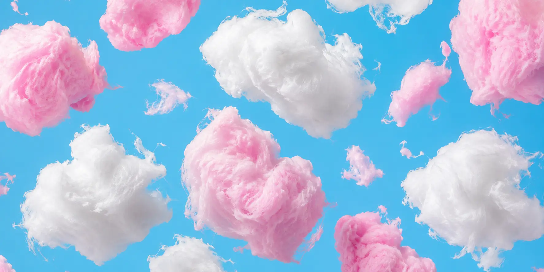 Pink and white cotton candy clouds on a blue background